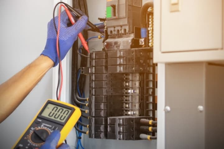 Home inspector examining electrical panel